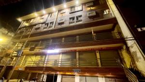 a tall building at night with its lights on at Pragati Guest House in Gorakhpur