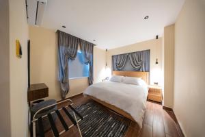 a bedroom with a large bed and two windows at B Suites Boutique Hotel in Amman +32 photos