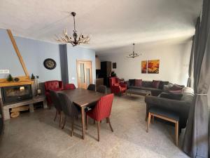 a living room with a table and chairs and a couch at Вила Планински перли, Дом 11 in Stoykite