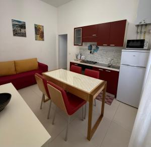a kitchen and living room with a table and chairs at Casa Bucalo 2, Taormina in Taormina