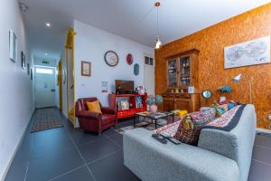 a living room with two couches and a table at A-Típica GuestHouse in Ponta Delgada