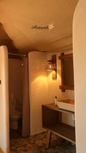 a bathroom with a sink and a toilet at Azawad Desert Luxury Camp in Merzouga