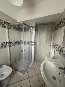 a bathroom with a shower and a toilet and a sink at Agherè in Agira