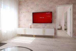 a living room with a tv on a wall at Iris Home in Székesfehérvár