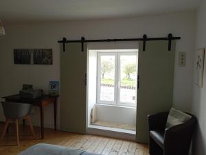 a window in a room with a chair and a desk at Le Cosy in Hiersac