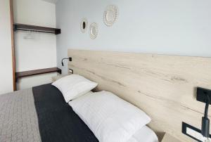 a bedroom with a bed with a wooden headboard at Dodekanisos Studios in Faliraki