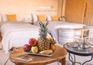 a tray of fruit on a table in a hotel room at Azawad Desert Luxury Camp in Merzouga +22 photos