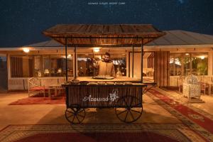 a man standing in front of a food cart at Azawad Desert Luxury Camp in Merzouga