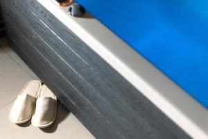 a pair of shoes sitting next to a wall at Acropoleos Suites in Thessaloniki