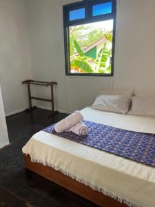 a bedroom with a bed with a towel on it at Maya Sunset Room, Coral Bay Perhentian Island in Perhentian Island +48 photos