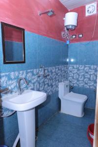 a bathroom with a sink and a toilet at Brahamkamal Resort in Gupta Kāshi