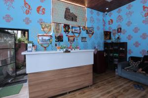 a bar in a room with blue wallpaper at Brahamkamal Resort in Gupta Kāshi