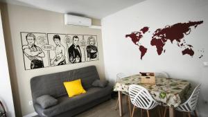 a living room with a couch and a world map on the wall at Hollywood Palazzo in Roses