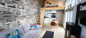 a living room with a couch and a brick wall at En aparté in Vielsalm
