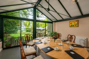 a dining room with a table and a large window at Penmorvah Manor Hotel in Falmouth +37 photos