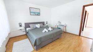 a bedroom with a bed in a white room at Kuća za odmor Franca in Ozalj