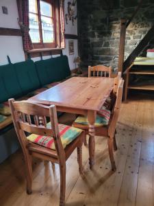 a wooden table and two chairs in a room at Alte Schmiede in Halver +2 photos