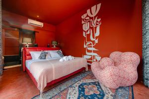 a bedroom with a bed and a heart chair at Afro Pool Villa Bangsean 01 in Ban Puk (2) +16 photos