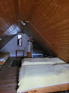 a large bed in a room with a wooden ceiling at Alte Schmiede in Halver