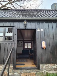 an open door of a wooden shed with a bench inside at Alte Schmiede in Halver