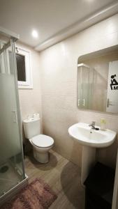 a bathroom with a toilet and a sink at Hollywood Palazzo in Roses +10 photos
