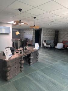 a lobby with a desk with a computer on it at Contact Hotel Utah Beach Carentan in Carentan