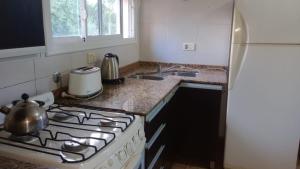 a kitchen with a stove and a refrigerator at Casa brisas del rey in San Antonio de Arredondo +10 photos
