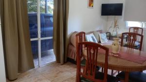 a dining room with a table and chairs and a couch at Casa brisas del rey in San Antonio de Arredondo