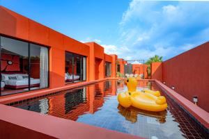 a pool with inflatable rafts on the side of a house at Afro Pool Villa Bangsean 01 in Ban Puk (2)