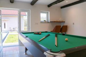 a billiard room with a pool table with balls and bats at Kuća za odmor Franca in Ozalj