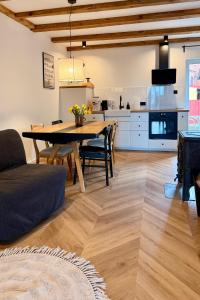 a living room with a dining room table and a kitchen at Blisko in Kuźnica +10 photos