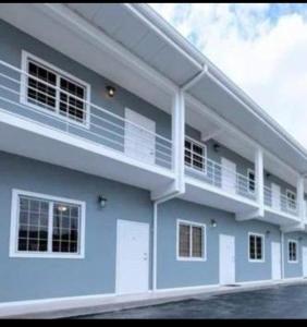 a building with balconies on the side of it at Cozy Modern flat in Tunapuna
