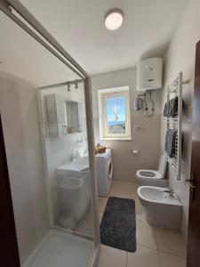 a bathroom with a shower and a toilet and a sink at Silent Lake View in Valentano +24 photos