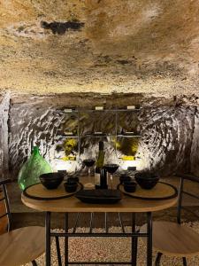 a table with wine glasses on it in a cave at Silent Lake View in Valentano