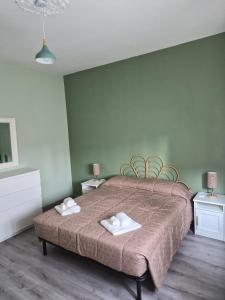 a bedroom with a bed with two towels on it at Ca d'la Mondina Apartment in Vercelli