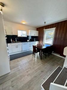 a kitchen and dining room with a table and chairs at Villa med 4 sovrum in Gothenburg +11 photos