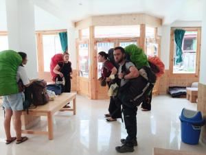 a group of people in a room with a man holding a child at Himalayan bite pulga in Kalgha