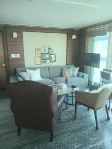 a living room with a couch and a table at 부산남포 프론트오션뷰 in Busan