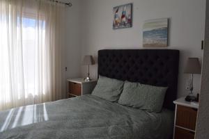 a bedroom with a large bed with a black headboard at Casa de la Serenidad in Mazarrón +37 photos