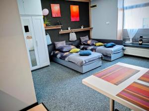 a living room with two beds and a couch at Apartament Na Reymonta in Starogard Gdański