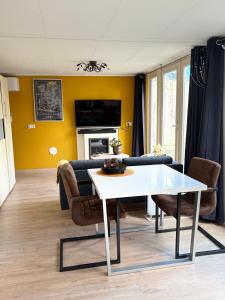 a living room with a table and a couch at Studio Watertoren in Goes