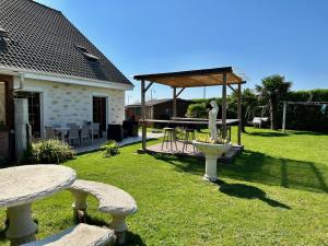 a yard with two stone benches and a fountain at Jardin Floral in Marquise
