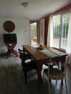 a dining room with a wooden table and chairs at LO de JIMENA in Los Cardales