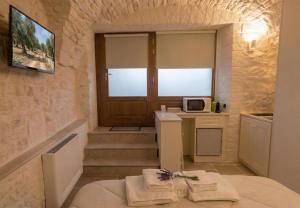 a room with a door and stairs with a microwave at Arcobaleno in Locorotondo