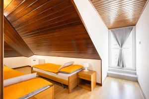 a bedroom with two beds and a wooden ceiling at Uno Due Tre Stella in Chioggia