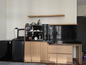 a kitchen with a sink and a microwave at Prova Home in Da Lat