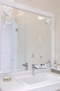 a bathroom with a sink and a large mirror at Modern Sea-View Maisonette in Spetses for 6 people in Spetses +48 photos