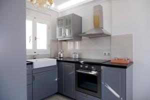 a kitchen with a sink and a stove at Modern Sea-View Maisonette in Spetses for 6 people in Spetses