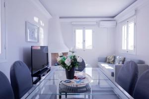 a living room with a couch and a table at Modern Sea-View Maisonette in Spetses for 6 people in Spetses