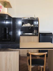 a kitchen with a black counter top and a stove at Prova Home in Da Lat +19 photos